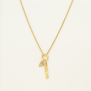 A gold necklace with the word “Mama” on it