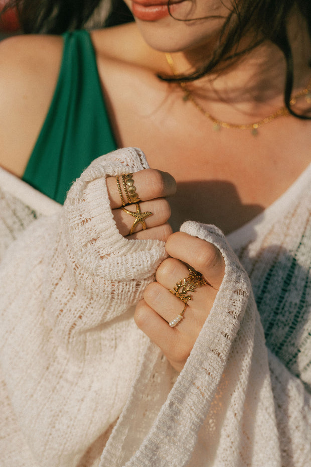 A dainty ring featuring coral-inspired design elements