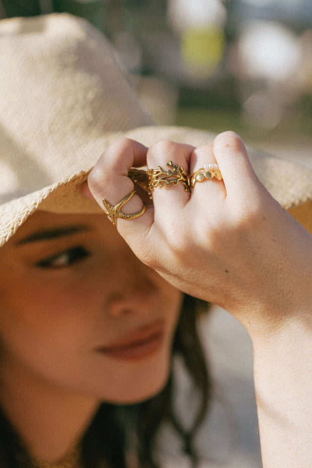 A dainty ring featuring coral-inspired design elements