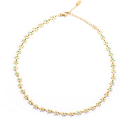 Flat lay of a gold plated choker made of small dainty gold flowers connected to make one necklace