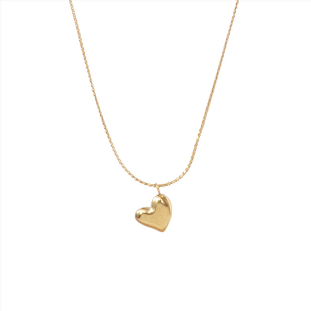 Dainty gold chain necklace with a small solid heart shaped gold pendant.