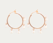 Small gold hoops accented with very small dangling white pearls.