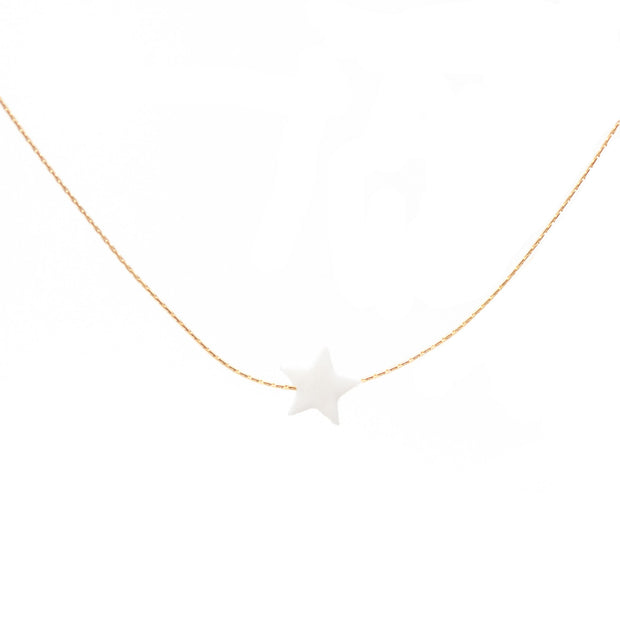 White pearl pendant in the shape of a star on a dainty gold chain.