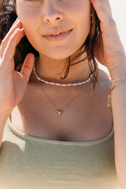 Model wearing a Gold necklace chain with a gold shark tooth pendant