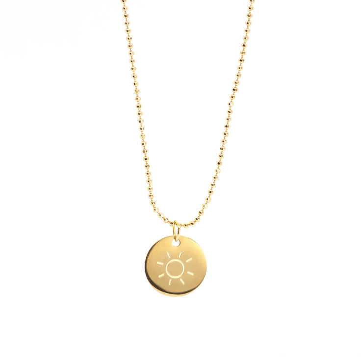 Dainty gold beaded necklace chain with a medium sized circular flat sun pendant.