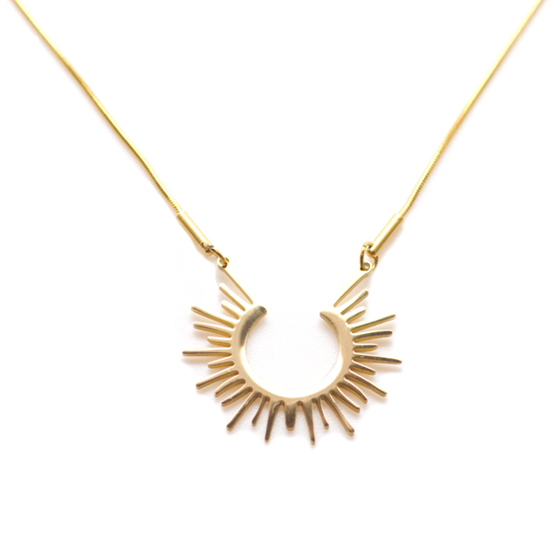 Dainty gold necklace chain with a medium sized circular flat sun pendant.